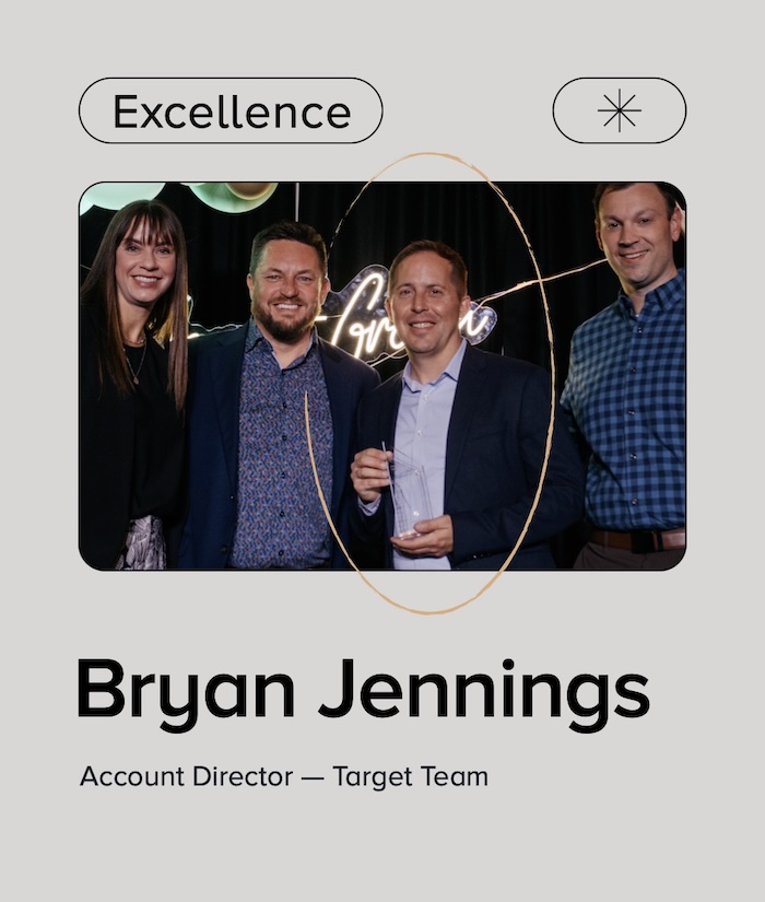 Graphic with text "Excellence" above photo with 3 men and a woman celebrating an award win. Text below reads "Bryan Jennings Account Director – Target Team"