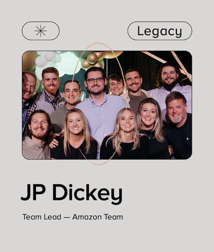 Graphic with text that reads "Legacy" above group photo with 9 men and 3 women celebrating an award win. Text below reads "JP Dickey Team Lead – Amazon Team"