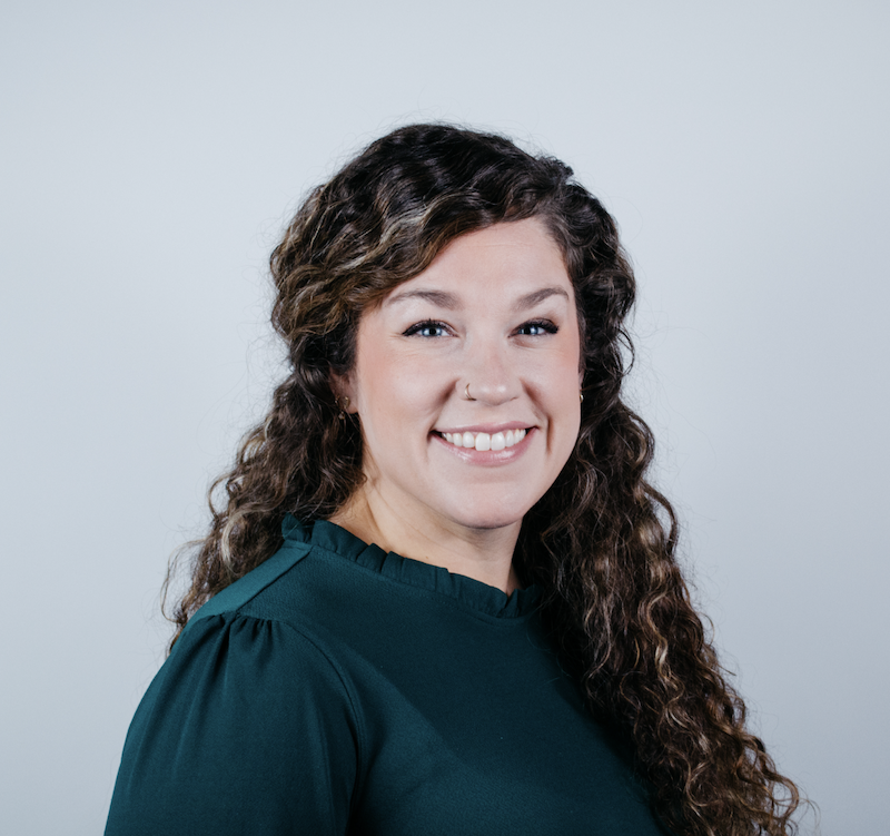 woman smiling wearing teal top